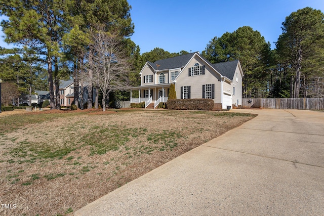 view of front facade with a porch, a garage, and a front yard