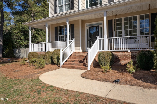 view of exterior entry featuring a porch