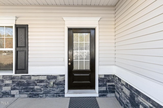 doorway to property with stone siding