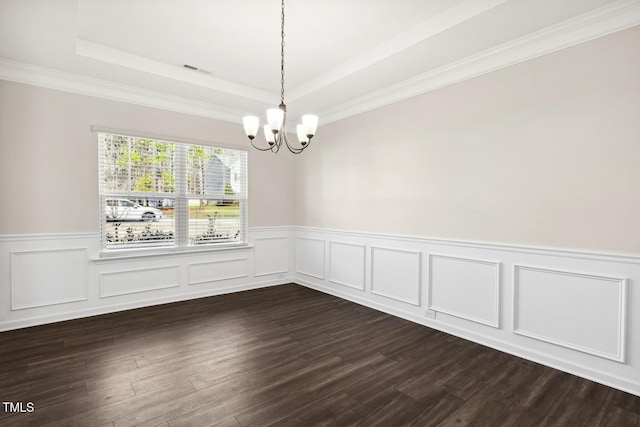 unfurnished dining area featuring a tray ceiling, dark wood finished floors, a notable chandelier, visible vents, and wainscoting