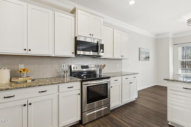 kitchen with white cabinets, light stone countertops, stainless steel appliances, and crown molding