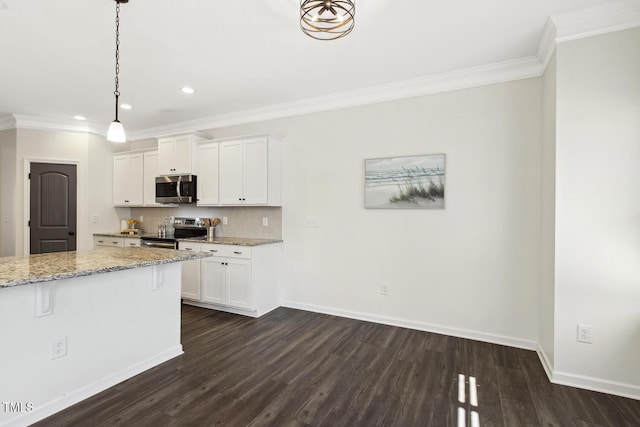 kitchen featuring white cabinets, light stone countertops, stainless steel appliances, crown molding, and pendant lighting