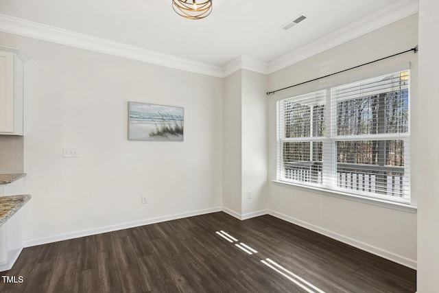 empty room featuring ornamental molding, dark wood-type flooring, visible vents, and baseboards