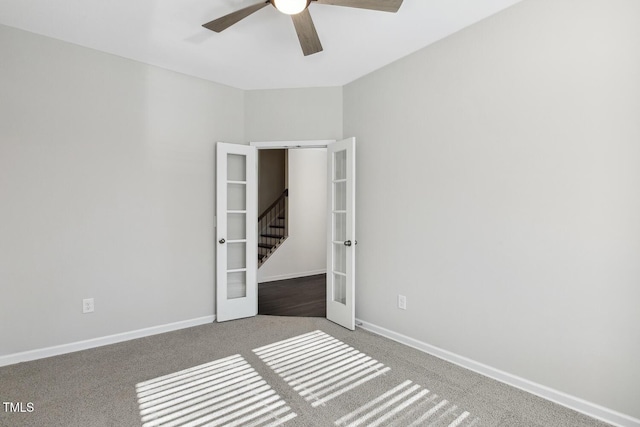 unfurnished room with carpet floors, french doors, a ceiling fan, and baseboards