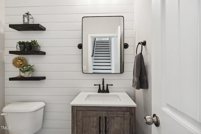 half bathroom featuring toilet and vanity