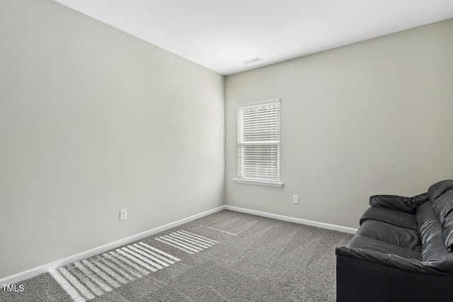 unfurnished room featuring carpet flooring, visible vents, and baseboards