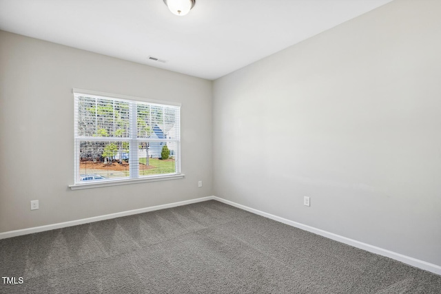 carpeted empty room featuring visible vents and baseboards