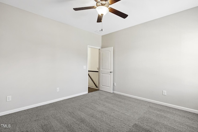 empty room with ceiling fan, carpet, and baseboards