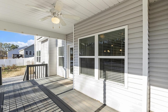 deck with ceiling fan and fence