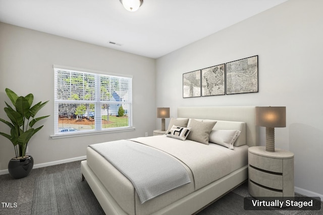 bedroom featuring baseboards, visible vents, and dark carpet
