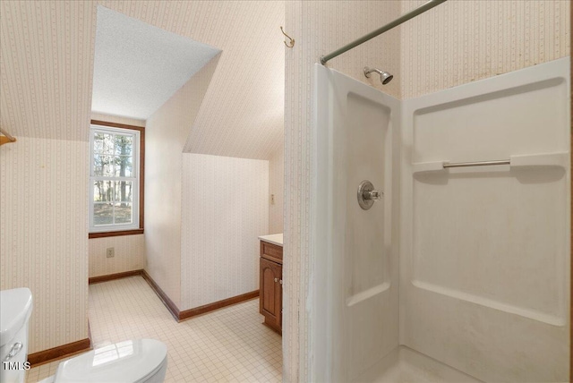 bathroom with toilet, a shower, vaulted ceiling, a textured ceiling, and vanity