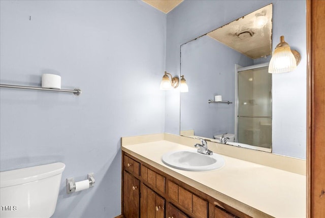 bathroom featuring vanity, toilet, and walk in shower