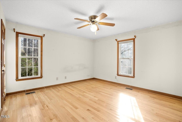 spare room featuring ceiling fan, a textured ceiling, and light wood-type flooring