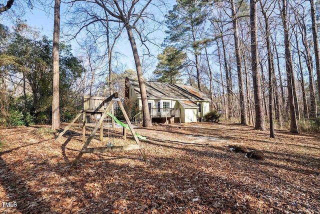 view of yard with a playground and a deck