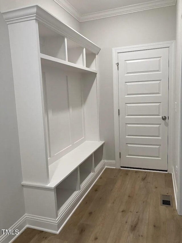 mudroom with hardwood / wood-style flooring and ornamental molding