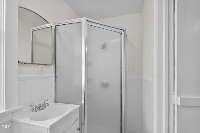 bathroom featuring vanity and a shower with shower door