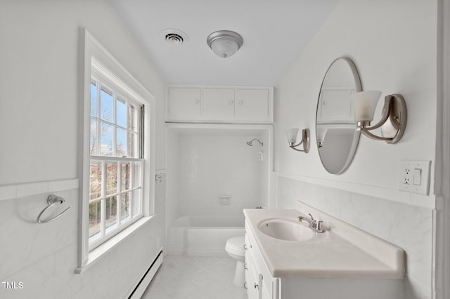 full bathroom with vanity, tiled shower / bath, a baseboard radiator, and toilet