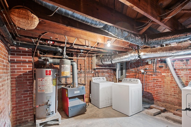 basement featuring washer and clothes dryer, gas water heater, and brick wall