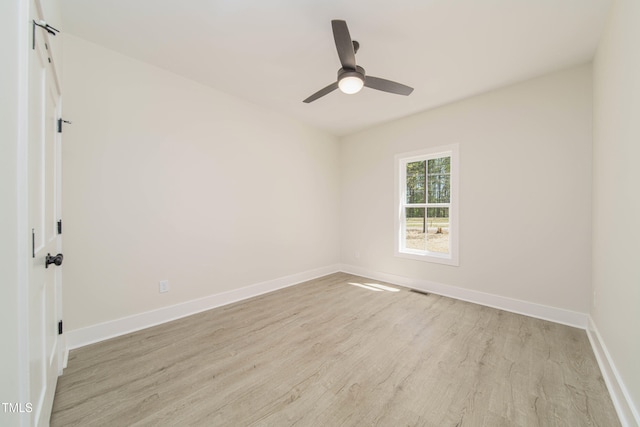 spare room featuring ceiling fan and light hardwood / wood-style flooring