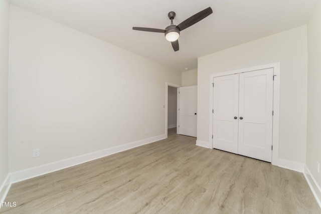 unfurnished bedroom with a closet, ceiling fan, and light wood-type flooring