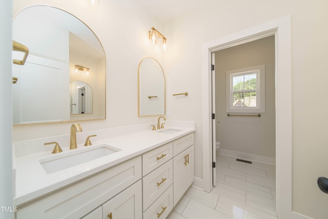 bathroom featuring vanity and toilet