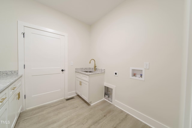 washroom with sink, cabinets, light wood-type flooring, hookup for a washing machine, and electric dryer hookup