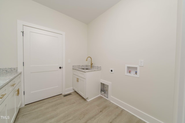 clothes washing area featuring sink, cabinets, washer hookup, hookup for an electric dryer, and light hardwood / wood-style flooring