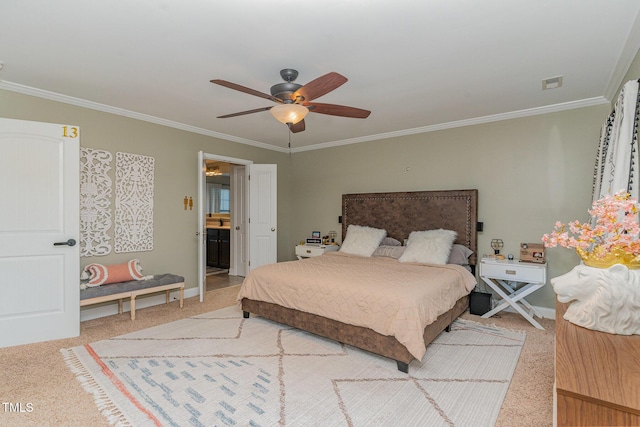 carpeted bedroom with ornamental molding, ceiling fan, and ensuite bath