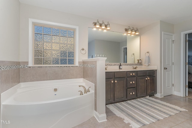 bathroom with tile patterned flooring, vanity, and a tub to relax in