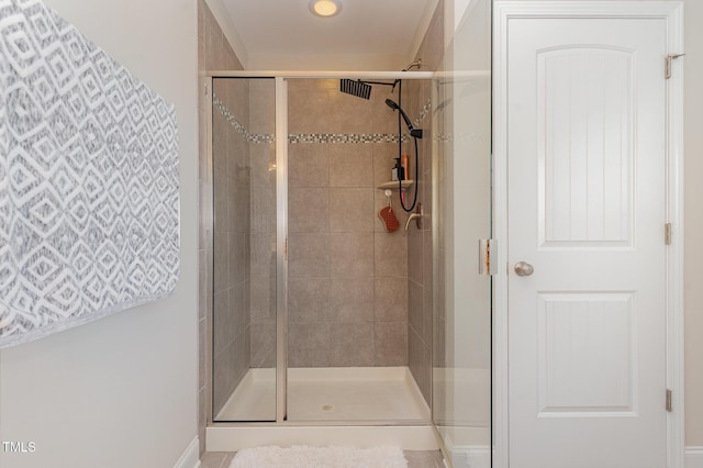 bathroom featuring a shower with door