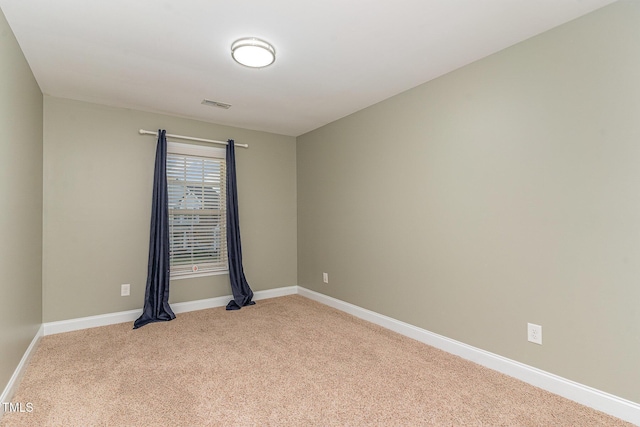 unfurnished room with light colored carpet