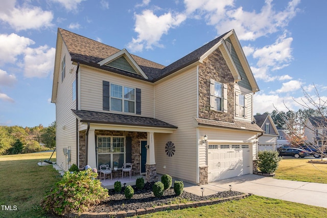 craftsman inspired home with a garage, a front lawn, and a porch