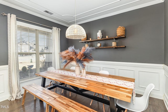 dining space with crown molding and dark hardwood / wood-style floors