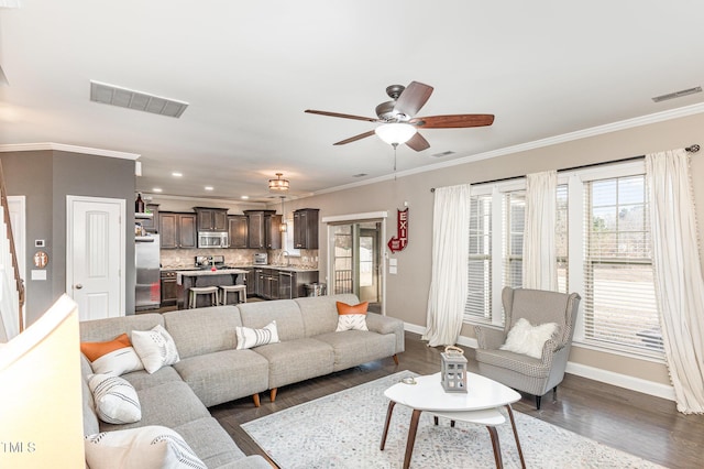 living room featuring ornamental molding, dark hardwood / wood-style floors, and ceiling fan