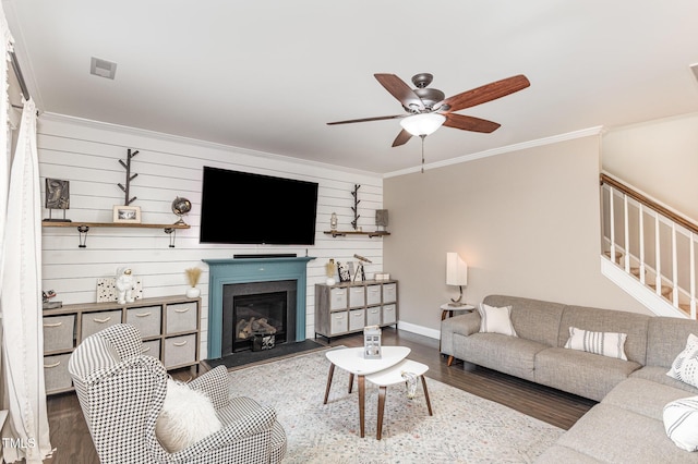 living room featuring ornamental molding, dark hardwood / wood-style floors, and ceiling fan