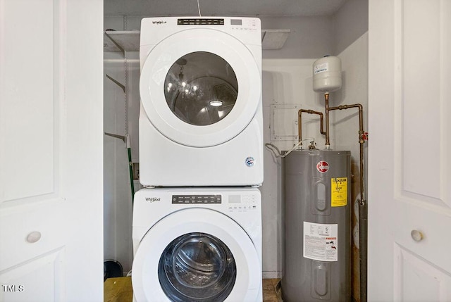 clothes washing area with stacked washer and clothes dryer, water heater, and laundry area