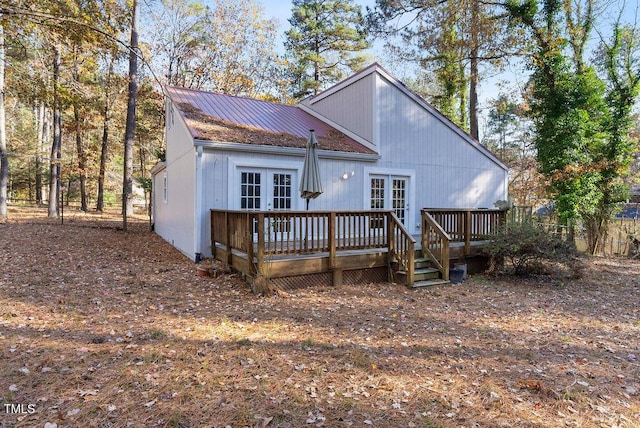 rear view of house featuring french doors, metal roof, and a deck