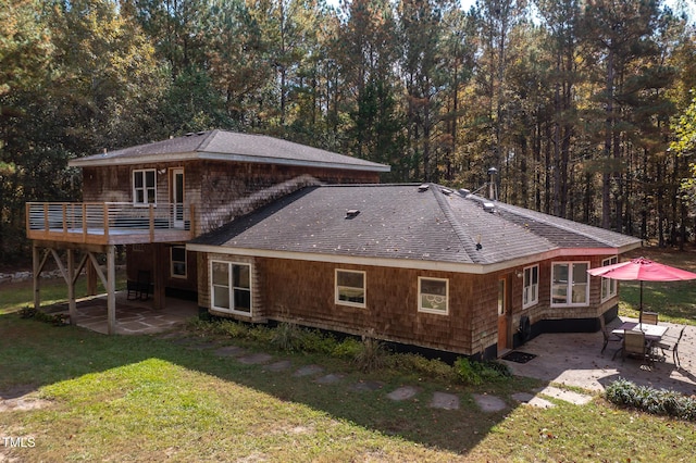 rear view of house with a yard and a patio area