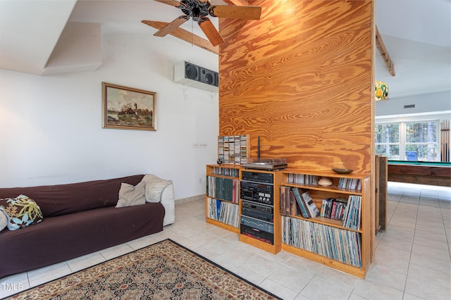 tiled living room featuring ceiling fan and vaulted ceiling