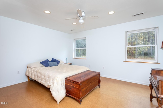 bedroom featuring ceiling fan and multiple windows