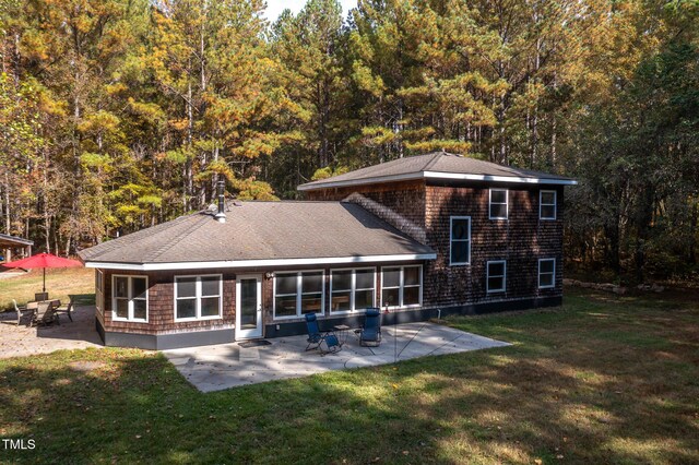 back of property with a patio and a lawn