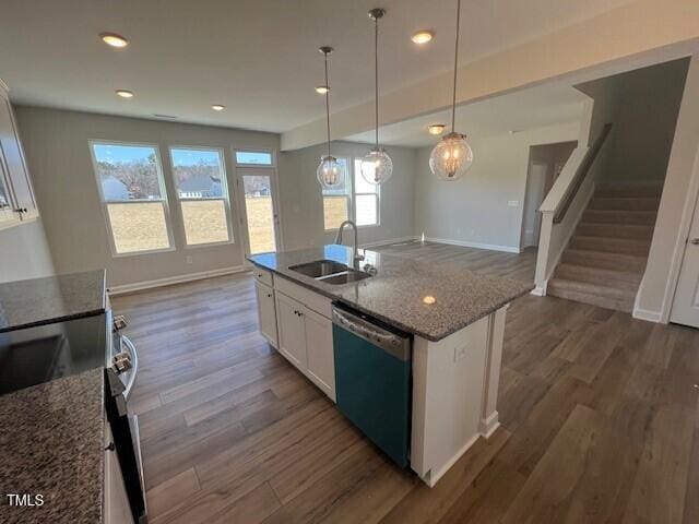 kitchen with white cabinets, dishwashing machine, dark wood-type flooring, stainless steel electric range, and a sink