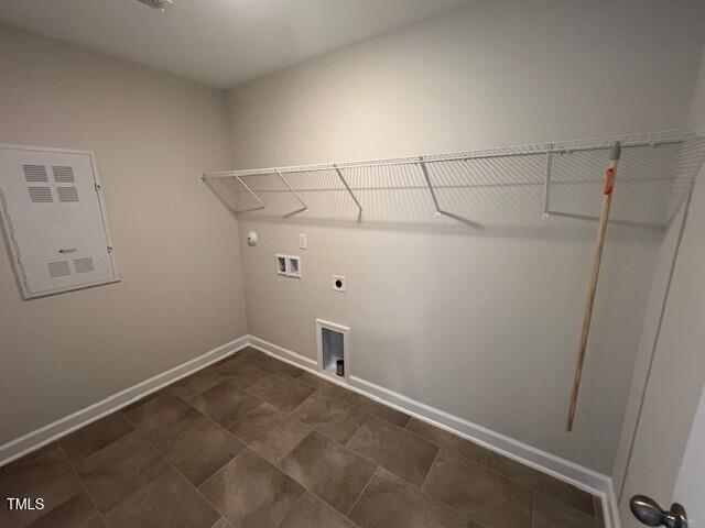 clothes washing area featuring hookup for a washing machine, hookup for a gas dryer, hookup for an electric dryer, laundry area, and baseboards