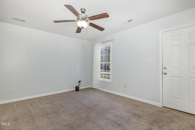 unfurnished room featuring ceiling fan and carpet floors