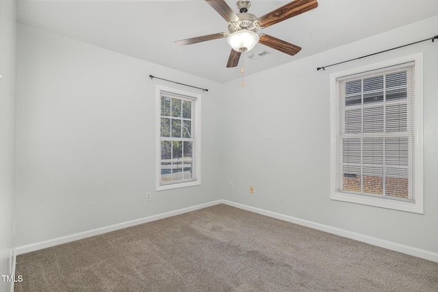 carpeted empty room featuring ceiling fan