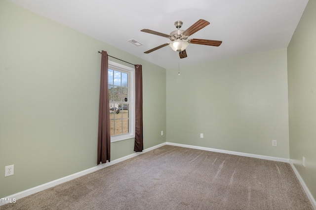 carpeted spare room with ceiling fan