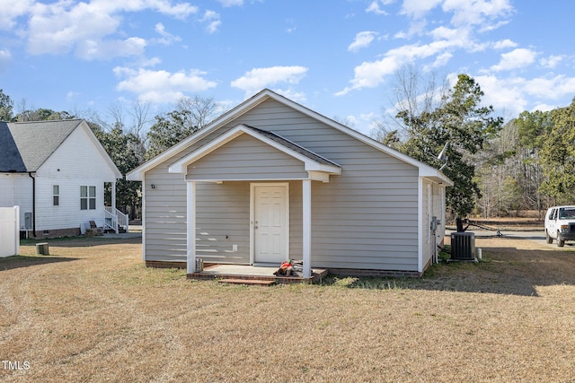 bungalow featuring a front yard and central AC unit