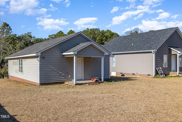 rear view of house with a yard