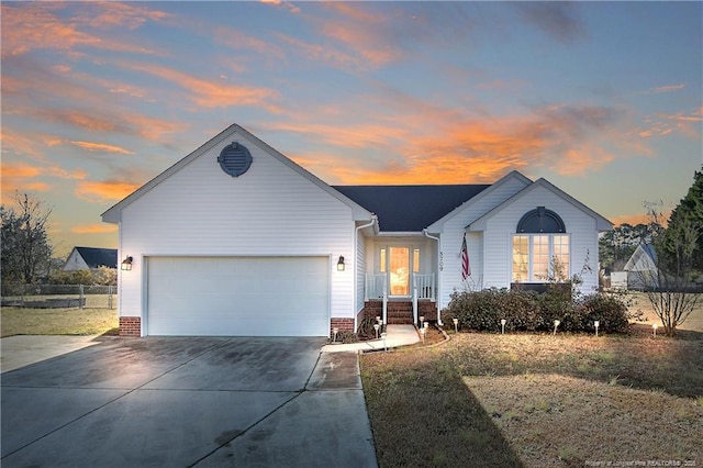 ranch-style home with a garage and a lawn