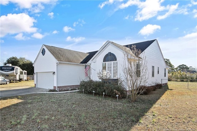 view of front facade with a garage and a front lawn